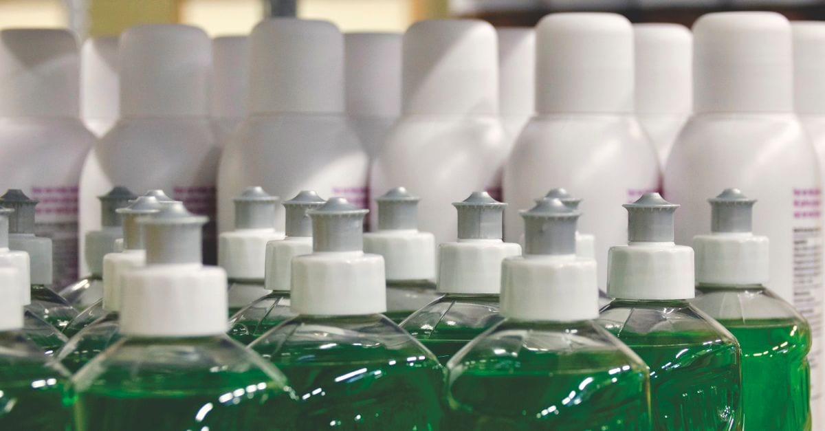 Close-up view of green liquid in bottles, ideal for household cleaning and stocks.