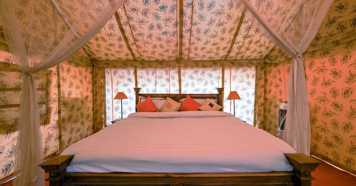 Elegant interior of a luxury tented bedroom in Jaisalmer, Rajasthan, India, featuring chic decor.