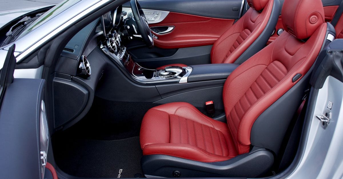 Explore the elegance of a luxury car's red leather interior, showcasing sleek design and AMG branding.