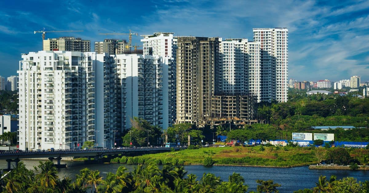 Stunning cityscape of Kochi's modern skyline with high-rise apartments and lush greenery.