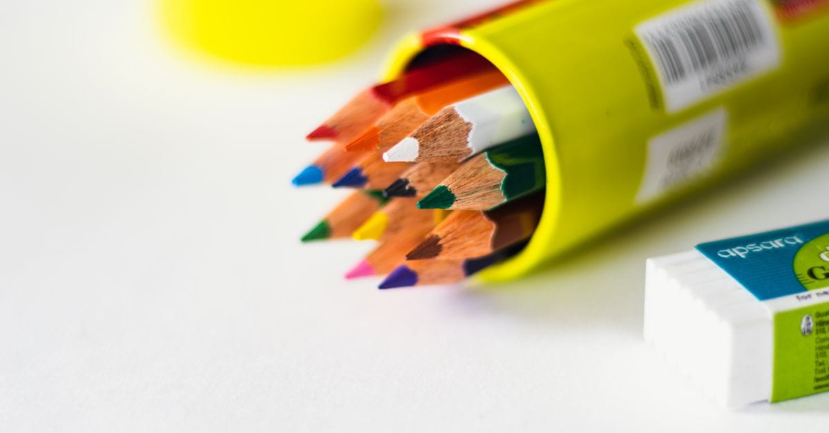 Close-up of vibrant colored pencils and eraser, perfect for creative projects.